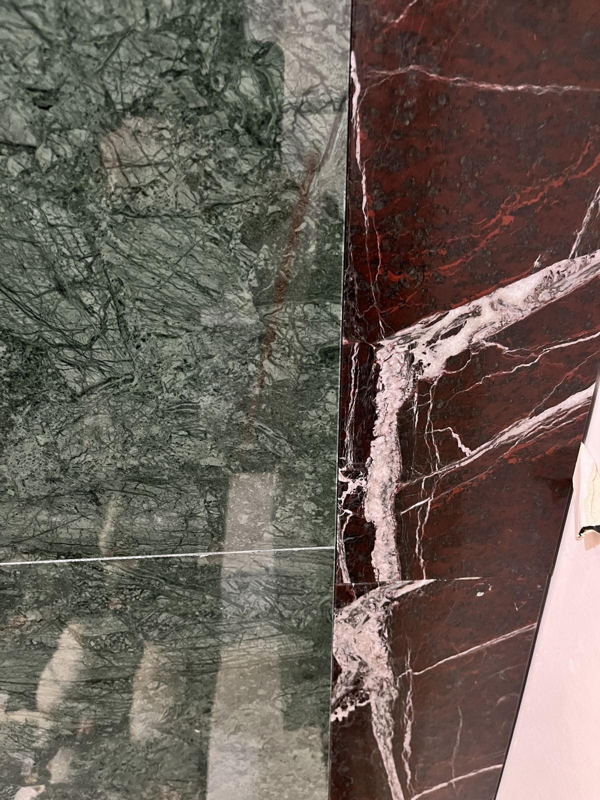 Green and red veined marble meeting at a corner