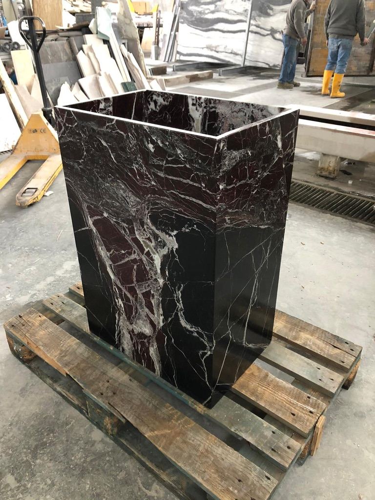 A basin cut from a single block of marble.