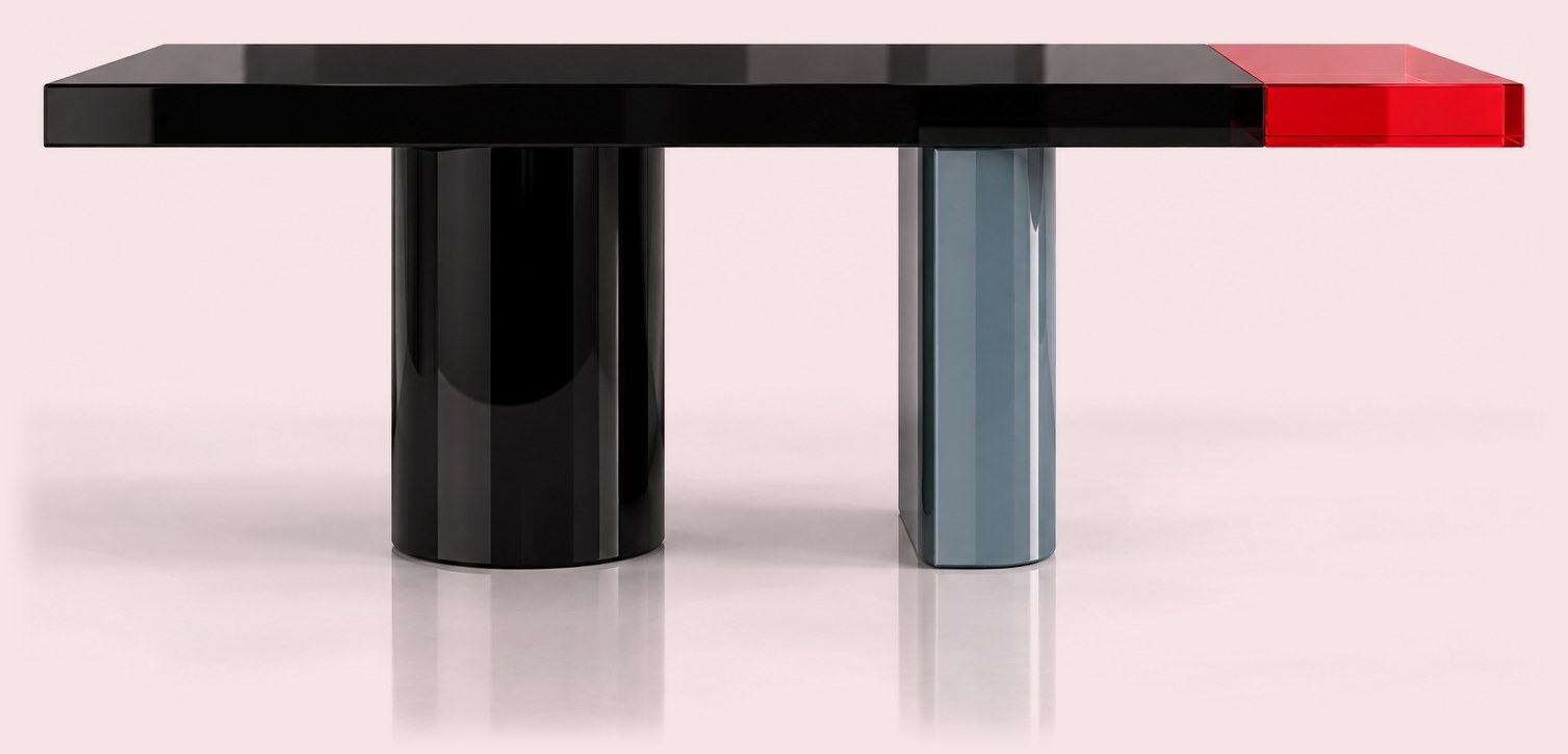 Black lacquered table with asymmetric black and blue-grey legs and a translucent red end