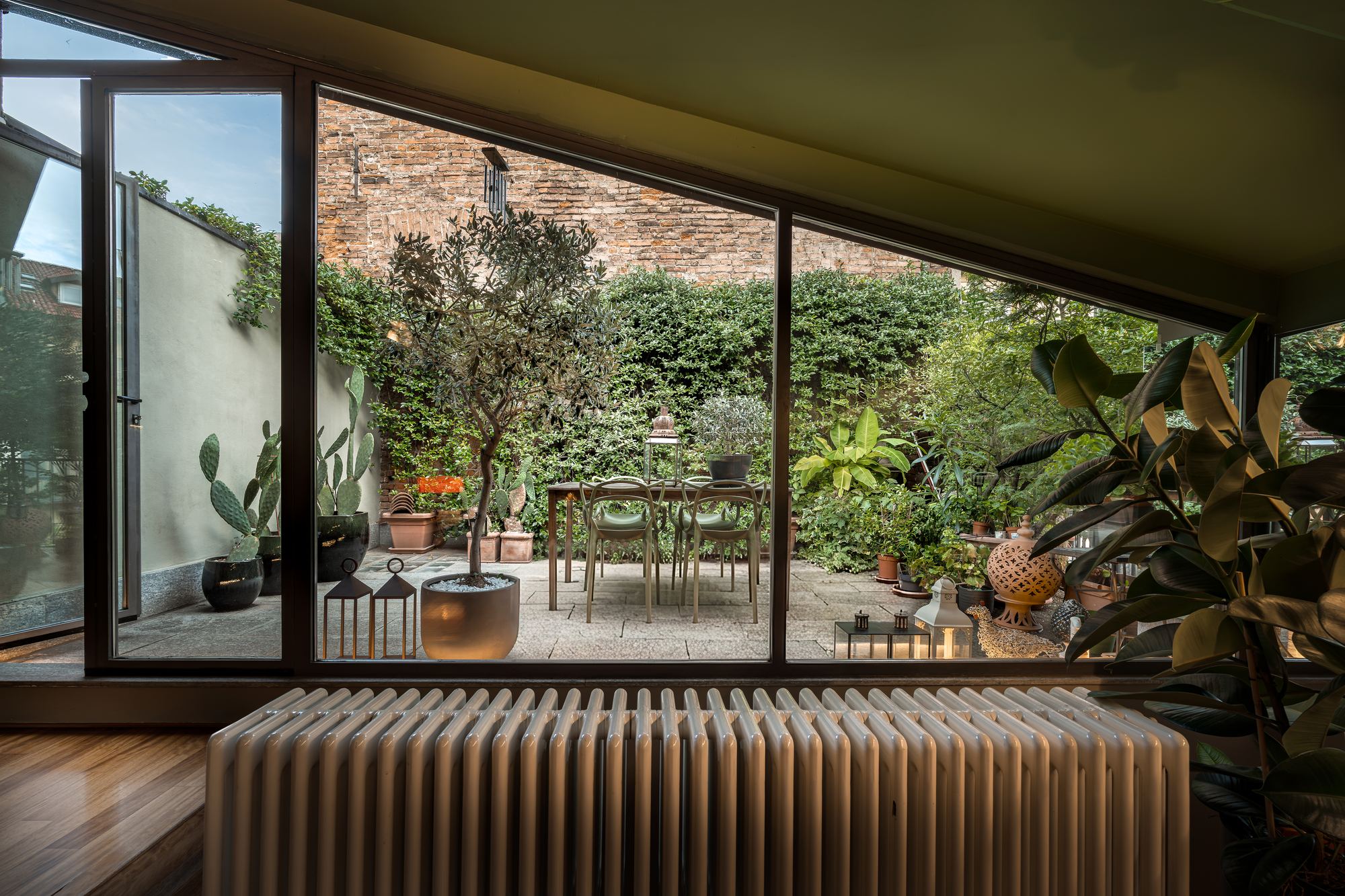 Glazed garden room looking out to the terrace and its table