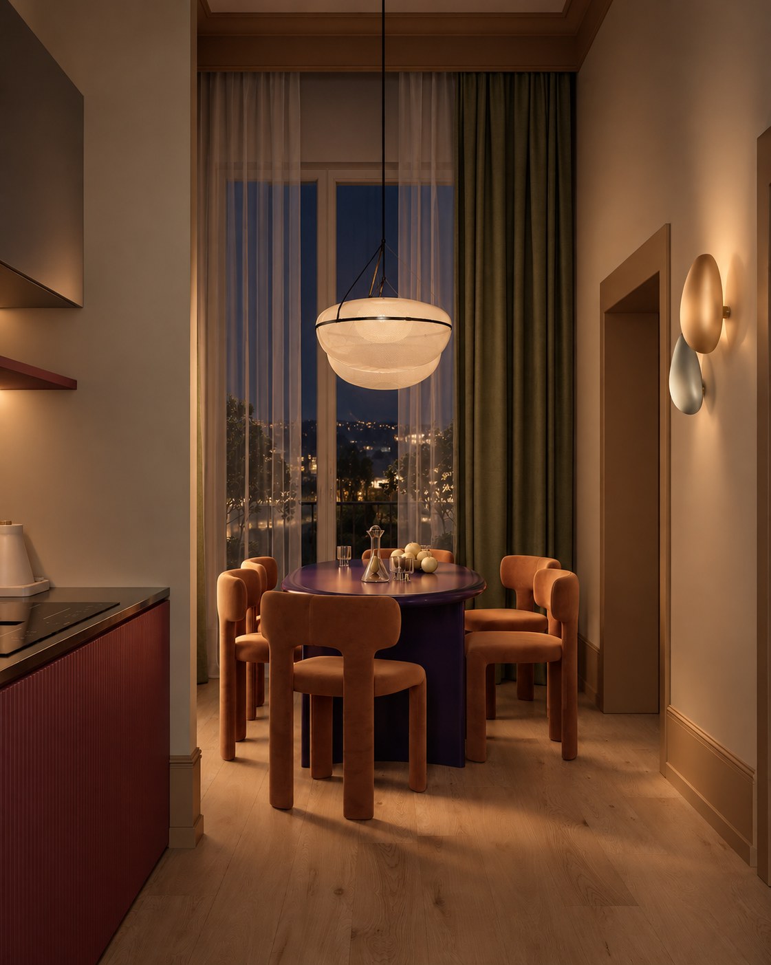 Dining room at night, the hills lit beyond the window