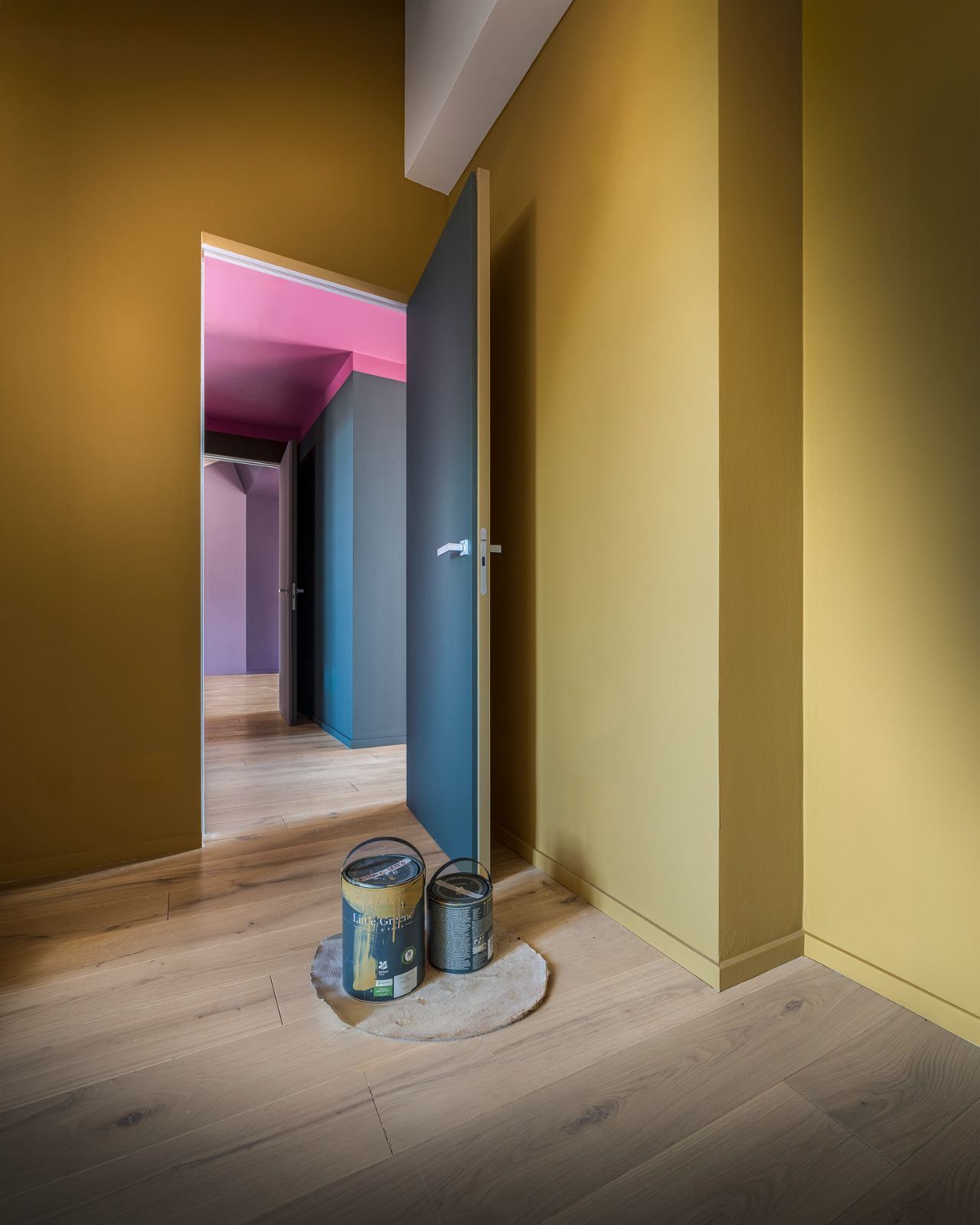 Yellow attic room with paint tins on the floor