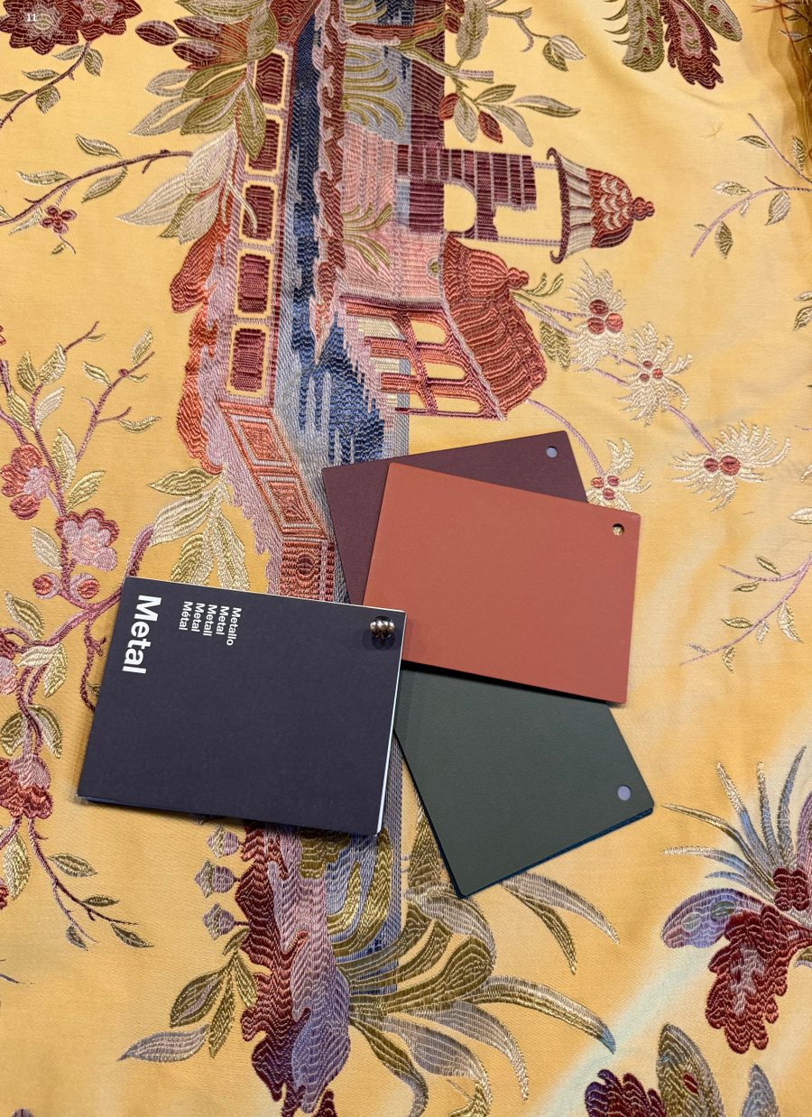Colour cards laid on embroidered chinoiserie fabric