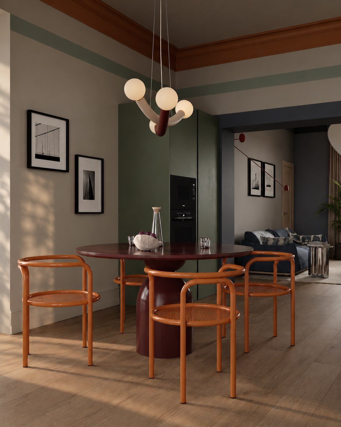 Dining table with orange chairs, the blue living room beyond